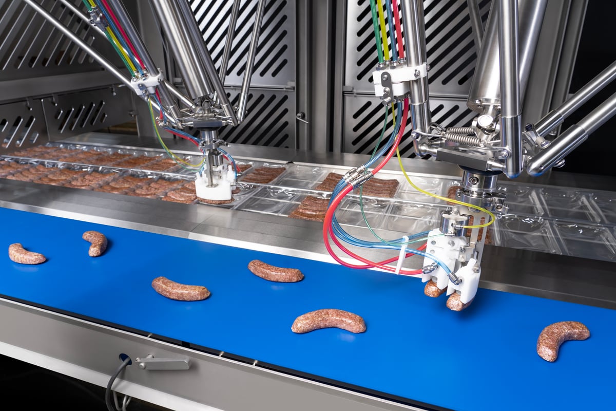 JLS Talon delta robots placing sausages into a thermoformer for packaging