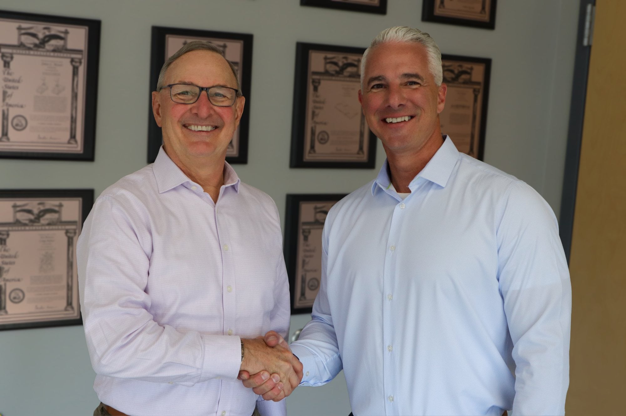 Craig Souser (left) and Russ Stroner shake hands at JLS Automation