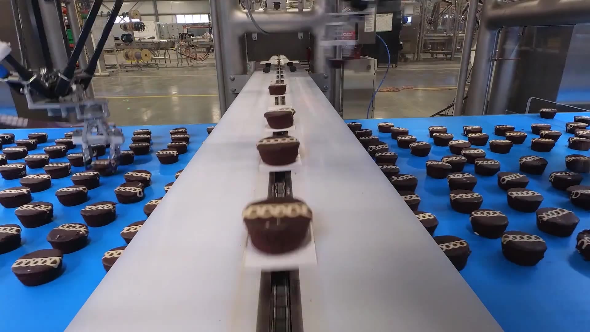 Talon robots loading snack cakes onto a flow-wrapper infeed