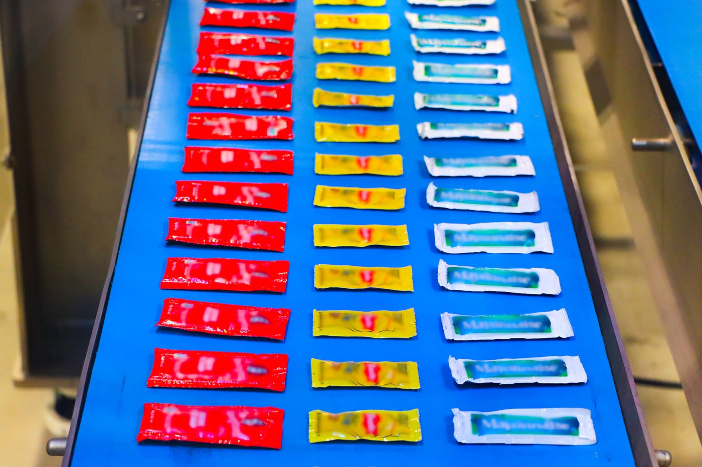 After: the same packets organized into rows by type and orientation by the JLS Vision AI-guided robot